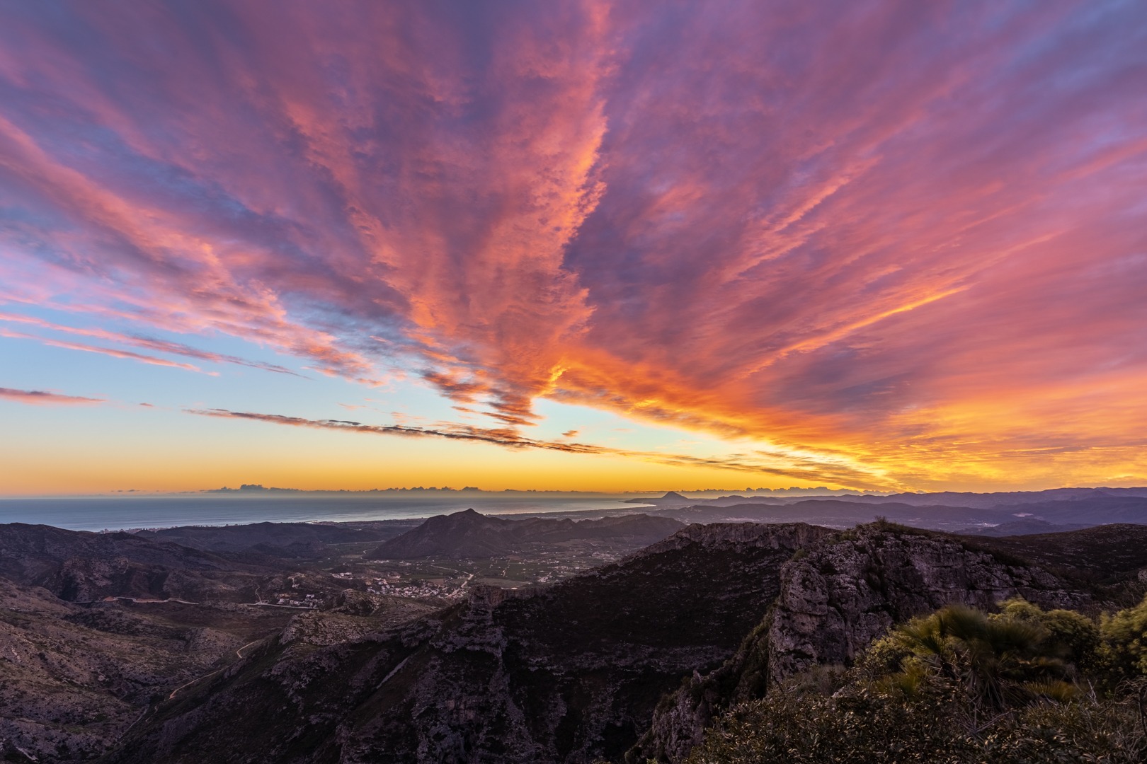 HDR image of the rising sun above the Spanish Costa Valencia with a sleepy mountain village